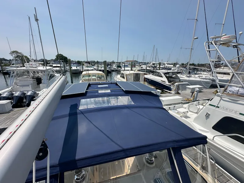 Slide: The Image of Sailboat Island Packet 439, 2021 model, docked at a marina with other boats. - 16