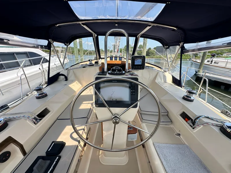 Slide: The Image of Cockpit of 2021 Island Packet 439 sailboat with navigation equipment and steering wheel. - 18