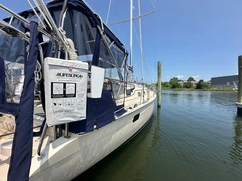 Slide: The Image of Sailboat Island Packet 439, 2021 model, docked with Lifesling rescue system visible. - 2