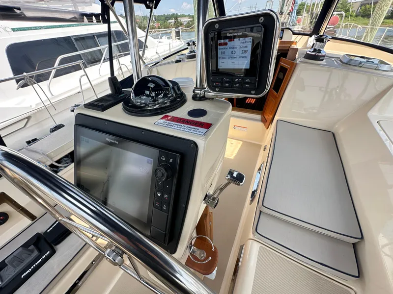 Slide: The Image of 2021 Island Packet 439 yacht cockpit with navigation equipment and seating. - 21