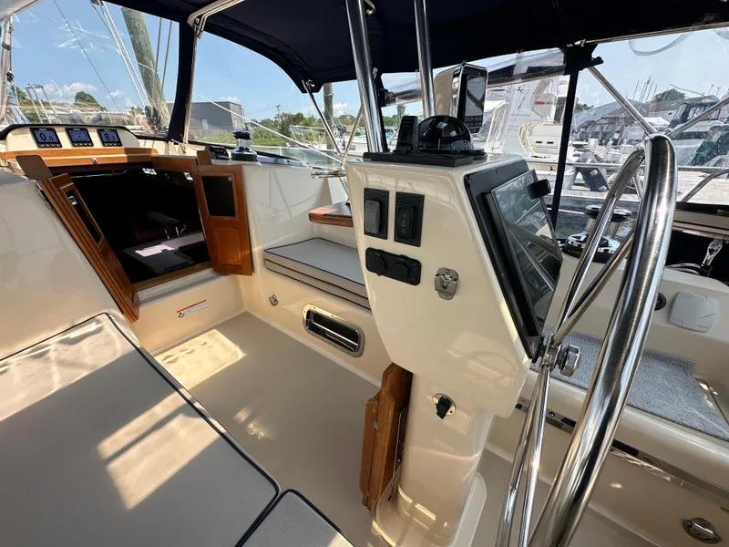 Slide: The Image of 2021 Island Packet 439 yacht cockpit with navigation controls and seating area. - 22