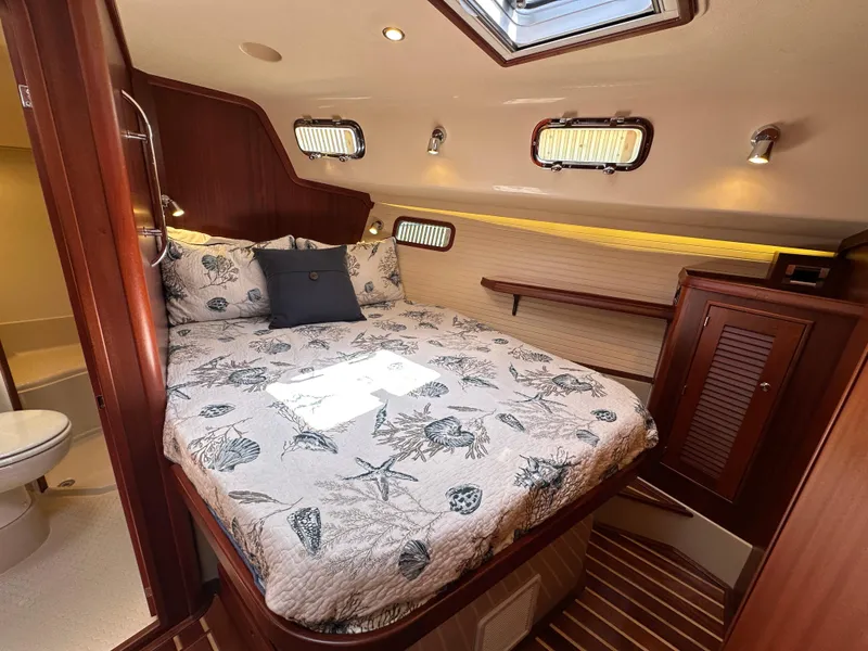 Slide: The Image of Luxurious cabin interior of 2021 Island Packet 439 yacht with cozy bed and elegant wood finish. - 41