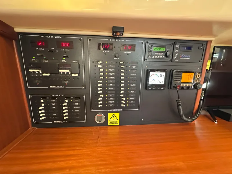 Slide: The Image of Electrical control panel on a 2021 Island Packet 439 yacht, featuring various switches and displays. - 47