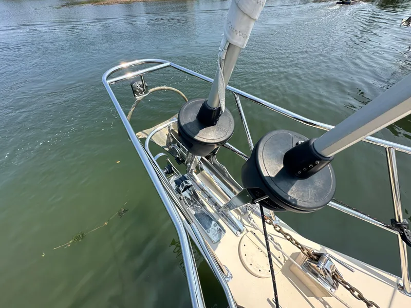 Slide: The Image of Bow of 2021 Island Packet 439 sailboat with dual furlers on calm water. - 9