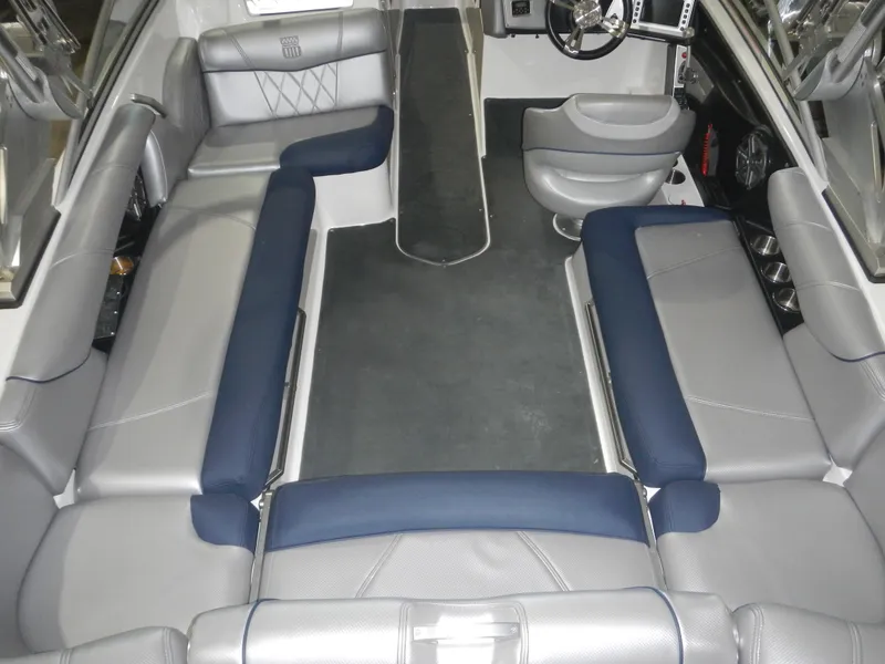 Slide: The Image of 2013 MasterCraft X30 boat interior with gray and blue seating arrangement. - 11
