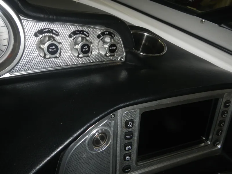 Slide: The Image of Dashboard of a 2013 MasterCraft X30 boat with control panel and display screen. - 14