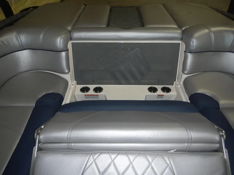 Slide: The Image of 2013 MasterCraft X30 boat interior with silver upholstery and cup holders. - 19