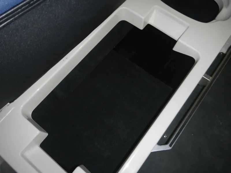 Slide: The Image of 2013 MasterCraft X30 boat storage compartment, black interior, white trim. - 22
