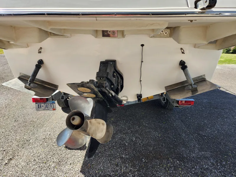 Slide: The Image of 2005 Regal Commodore 2765 boat stern with propeller and trim tabs visible. - 11