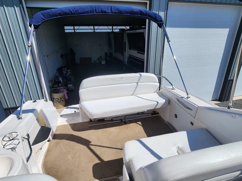 Slide: The Image of 2005 Regal Commodore 2765 boat interior with white seating and blue canopy. - 17