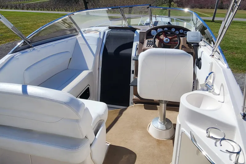 Slide: The Image of 2005 Regal Commodore 2765 boat interior with white seating and steering console. - 18