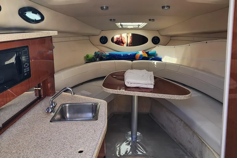 Slide: The Image of 2005 Regal Commodore 2765 cabin interior with kitchenette, sink, and seating area. - 23