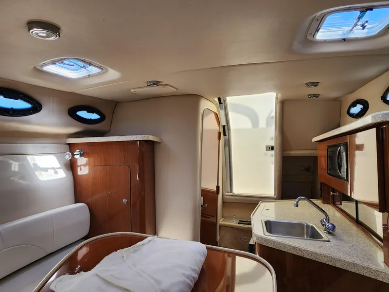 Slide: The Image of 2005 Regal Commodore 2765 cabin interior with kitchenette, sink, and seating area. - 24