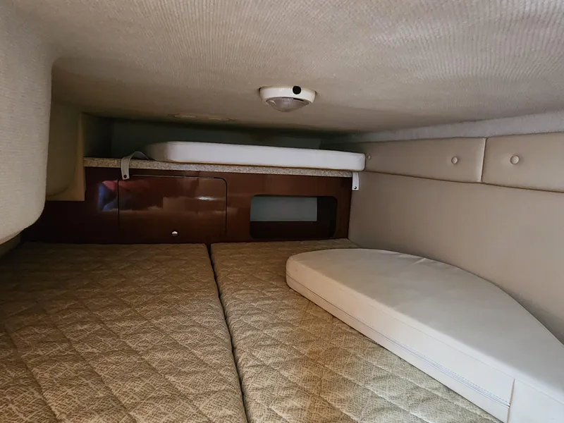 Slide: The Image of 2005 Regal Commodore 2765 cabin interior with beige upholstery and compact sleeping area. - 25