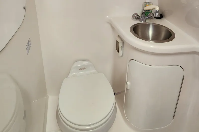 Slide: The Image of Compact bathroom in 2005 Regal Commodore 2765 boat with toilet and sink. - 27