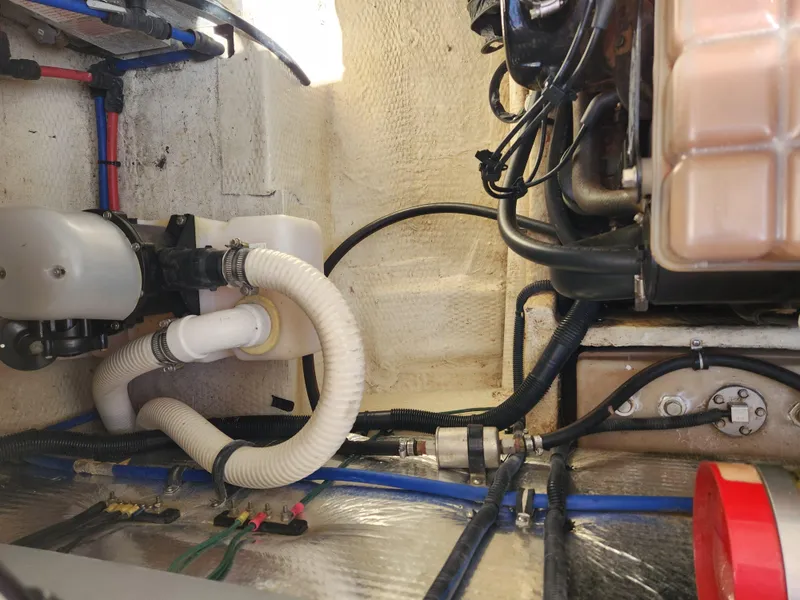 Slide: The Image of Engine compartment of a 2005 Regal Commodore 2765 boat, showing hoses and mechanical components. - 29