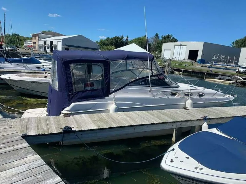 Slide: The Image of 2005 Regal Commodore 2765 boat docked at marina with blue canopy. - 3