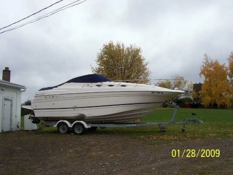 Slide: The Image of 2005 Regal Commodore 2765 boat on trailer, parked outdoors, overcast sky. - 5