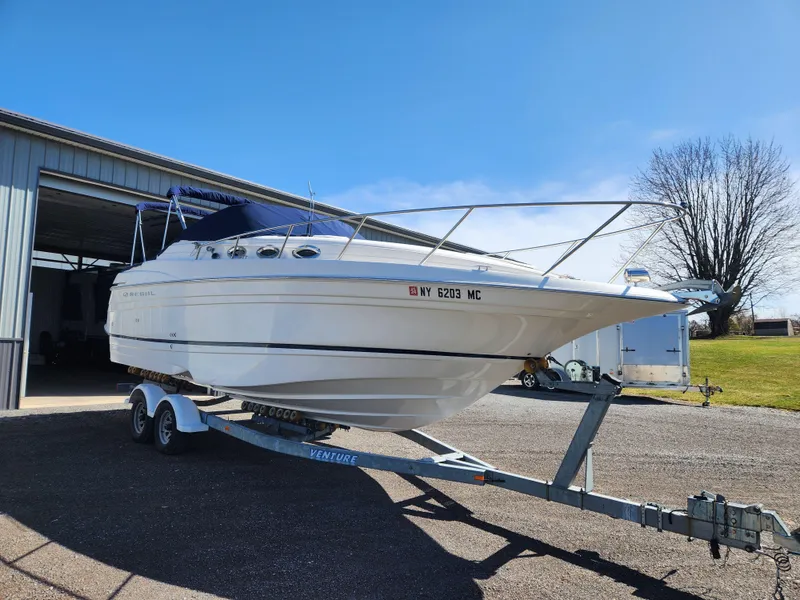 Slide: The Image of 2005 Regal Commodore 2765 boat on trailer, parked outside a garage. - 7
