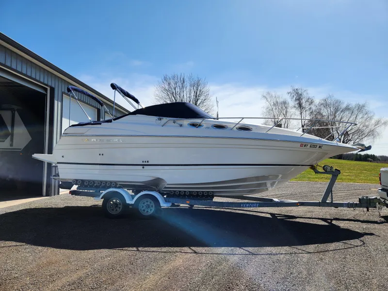Slide: The Image of 2005 Regal Commodore 2765 boat on trailer, parked outside a garage. - 8