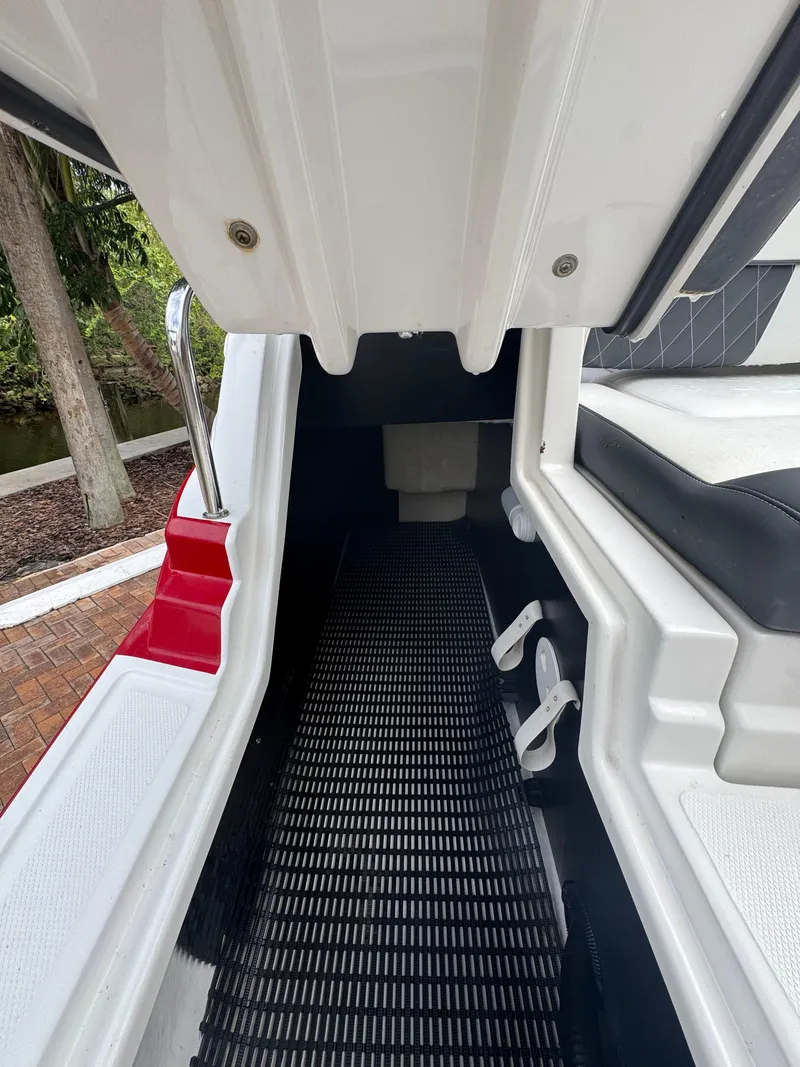 Slide: The Image of 2020 Monterey M65 boat interior with seating and walkway, featuring sleek design elements. - 16