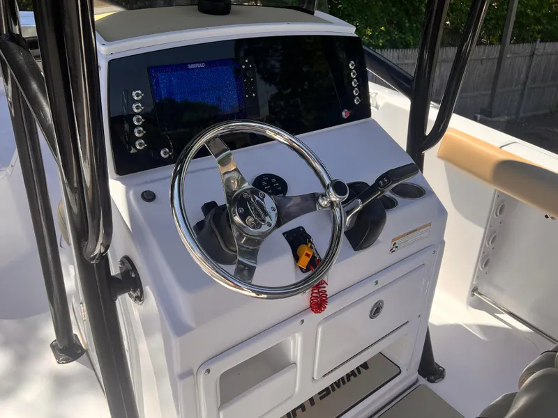 Slide: The Image of 2018 Sportsman Open 232 Center Console dashboard with steering wheel and navigation controls. - 4