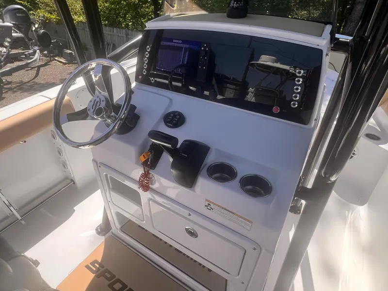 Slide: The Image of 2018 Sportsman Open 232 Center Console boat dashboard with steering wheel and controls. - 5