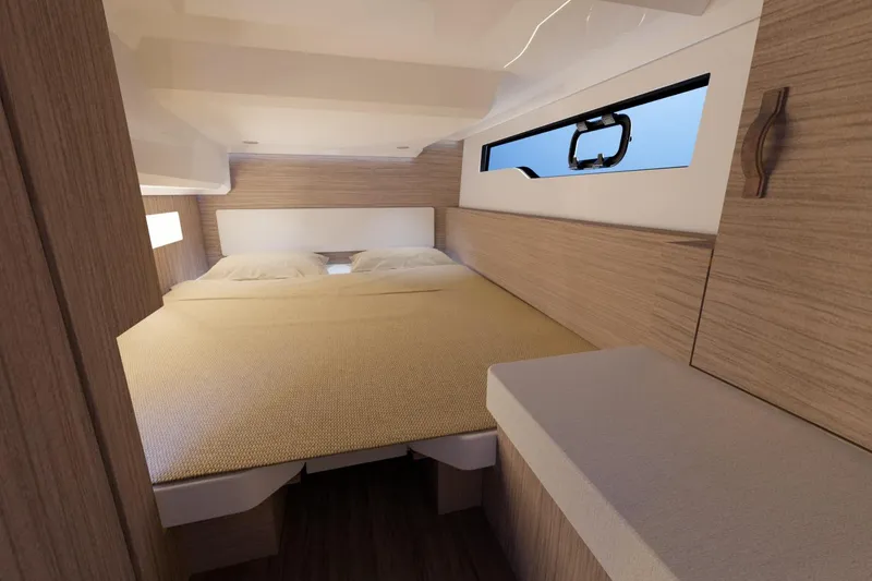 Slide: The Image of 2026 Jeanneau NC 1095 FLY S2 cabin interior with cozy bed and modern wood finish. - 8