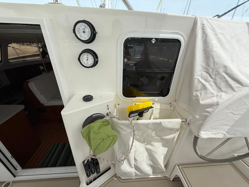 Slide: The Image of 2021 Antares 44GS yacht cockpit with gauges, storage, and cleaning tools. - 10