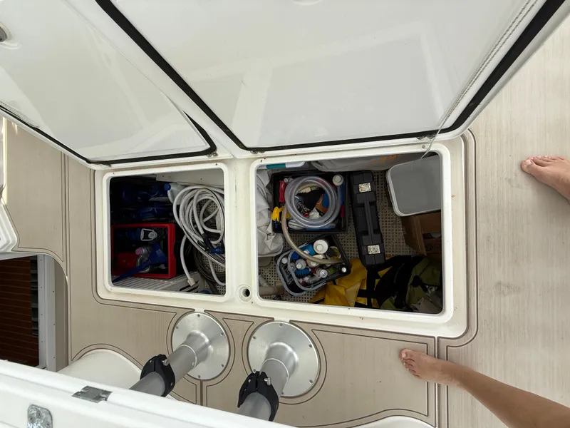 Slide: The Image of Storage compartment on 2021 Antares 44GS boat, containing various tools and equipment. - 13