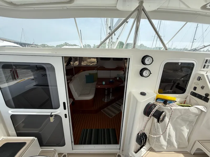 Slide: The Image of Interior view of 2021 Antares 44GS yacht, featuring a cozy seating area and nautical instruments. - 16