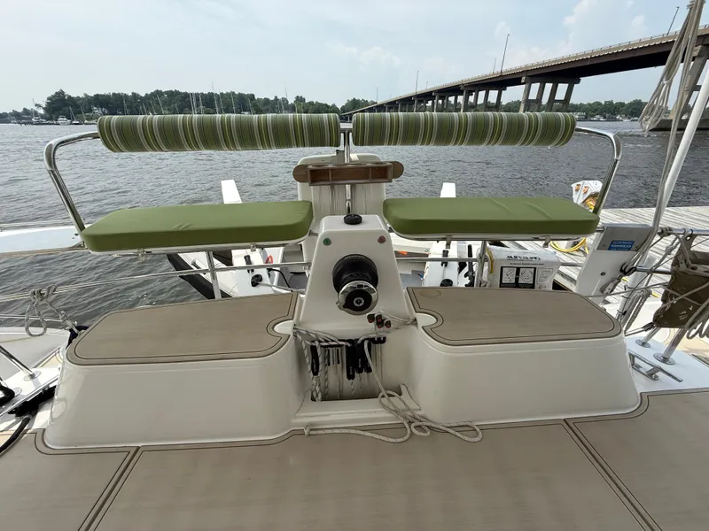 Slide: The Image of Helm of 2021 Antares 44GS yacht with green seating, docked by a bridge. - 17