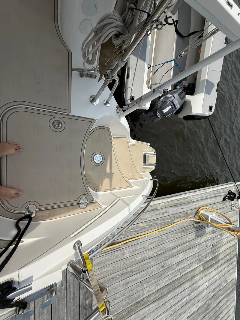 Slide: The Image of Deck view of 2021 Antares 44GS yacht docked by wooden pier. - 19