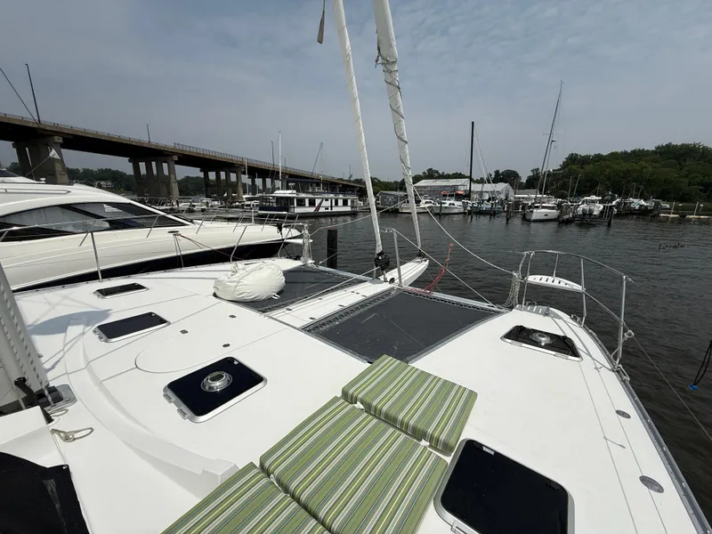 Slide: The Image of Sailing yacht Antares 44GS (2021) docked at marina with striped cushions on deck. - 28