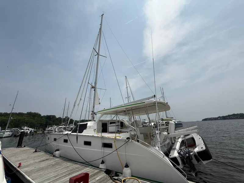Slide: The Image of Sailing catamaran Antares 44GS 2021 docked at a marina under a cloudy sky. - 3
