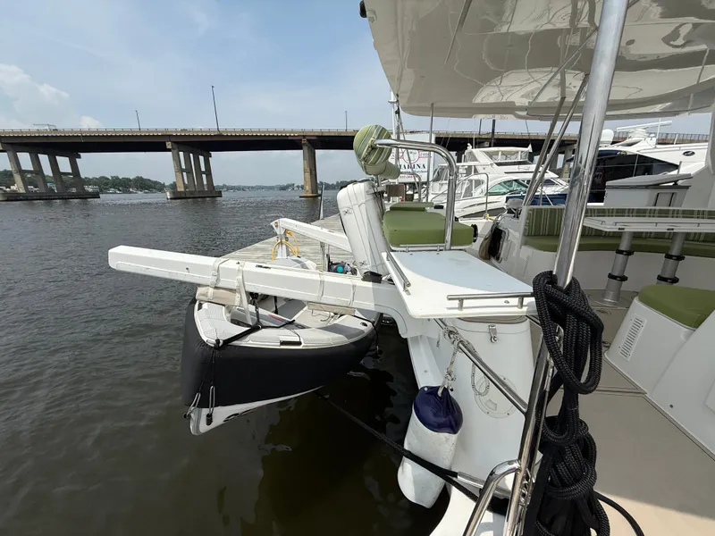 Slide: The Image of 2021 Antares 44GS yacht docked near a bridge, featuring a small boat on the deck. - 35