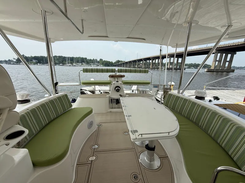 Slide: The Image of 2021 Antares 44GS yacht interior with green seating, table, and water view. - 36