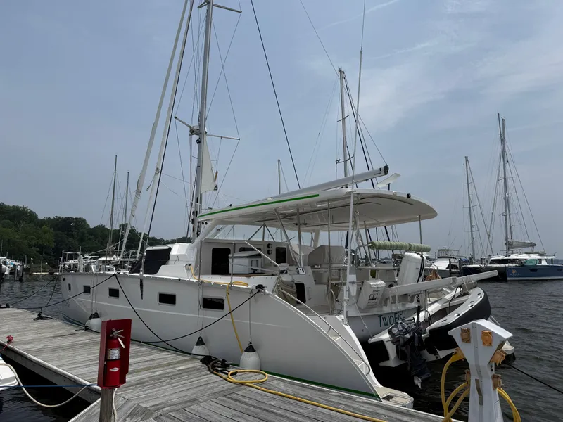 Slide: The Image of 2021 Antares 44GS catamaran docked at a marina, featuring sleek design and modern amenities. - 4