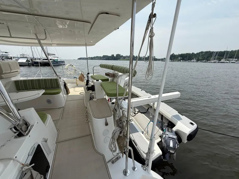 Slide: The Image of Sleek 2021 Antares 44GS yacht docked by the water, showcasing spacious deck and seating. - 41