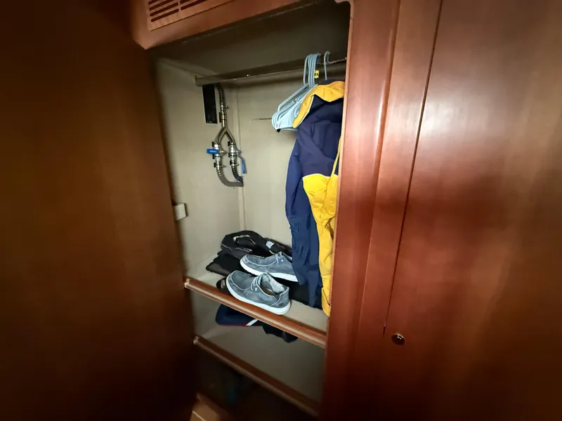 Slide: The Image of Wooden closet interior with clothes and shoes, Antares 44GS 2021 model. - 46