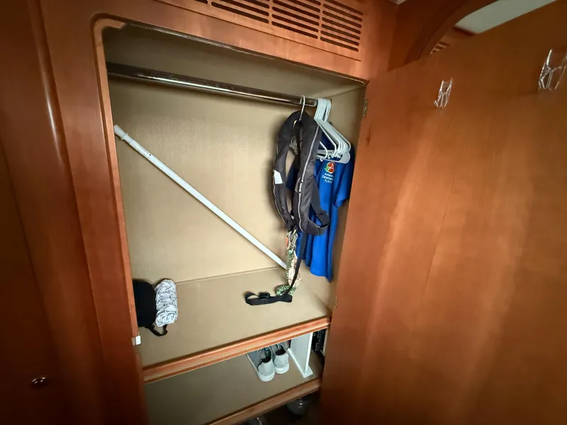 Slide: The Image of Wooden closet interior on Antares 44GS 2021 yacht with clothes and shoes. - 47