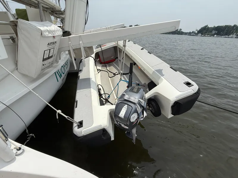 Slide: The Image of 2021 Antares 44GS sailboat with attached motorized dinghy on calm water. - 7