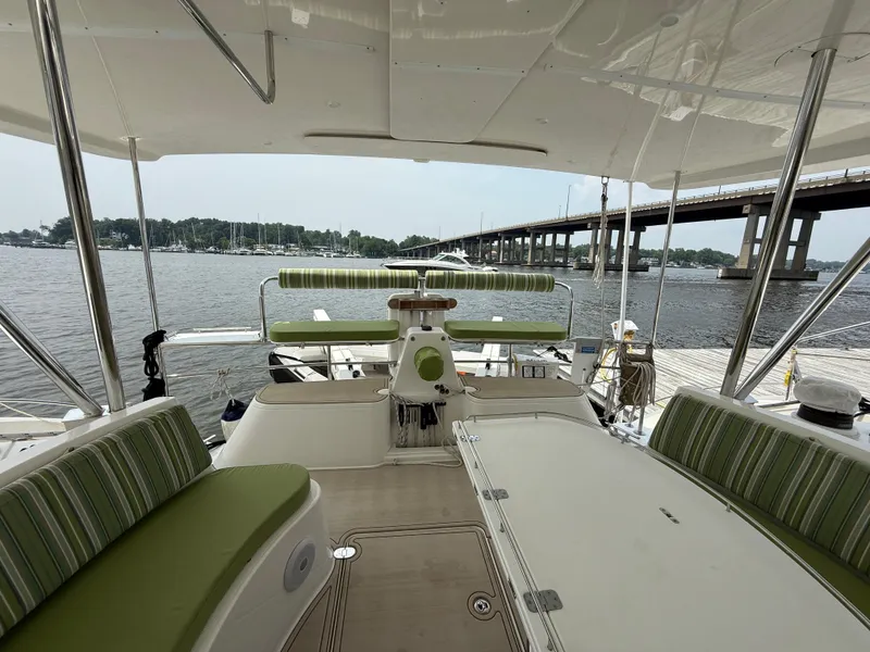 Slide: The Image of Luxurious Antares 44GS yacht interior with green-striped seating, docked by a scenic waterfront. - 9