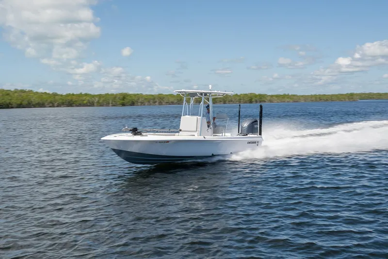 The Image of 2024 Contender 26 Bay boat speeding on open water under clear skies. - 0