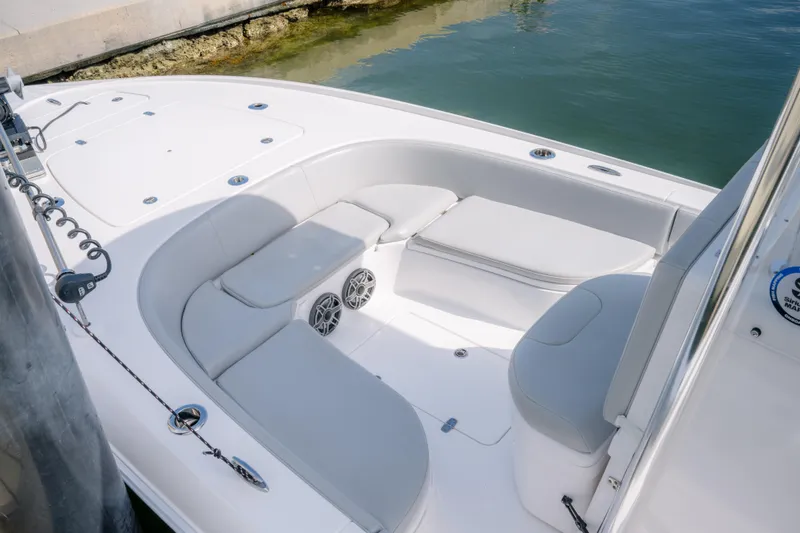 Slide: The Image of 2024 Contender 26 Bay boat interior with cushioned seating and speakers. - 13