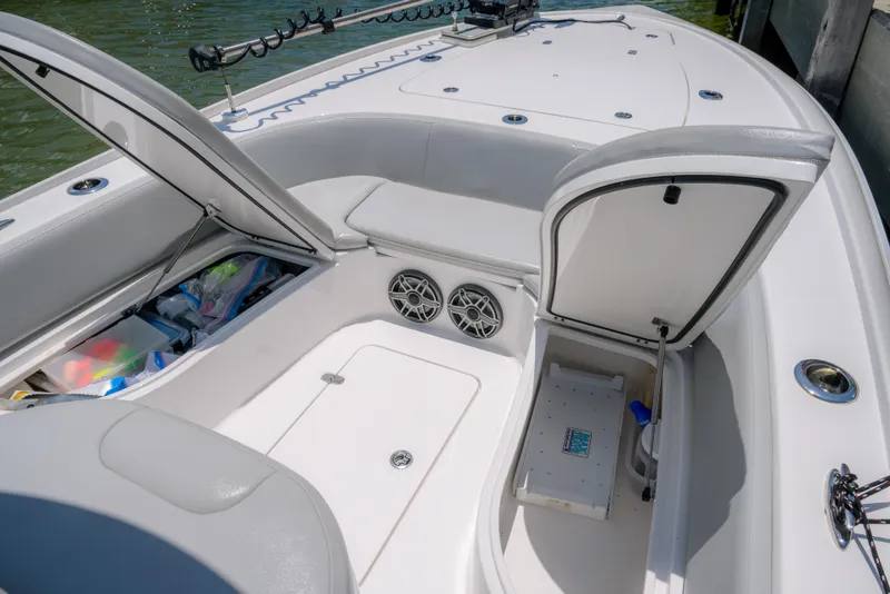 Slide: The Image of 2024 Contender 26 Bay boat interior with open storage compartments and seating. - 14