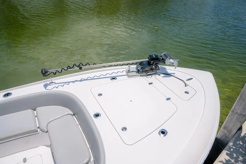 Slide: The Image of 2024 Contender 26 Bay boat bow with trolling motor on calm water. - 20