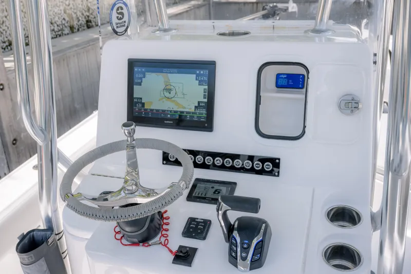 Slide: The Image of 2024 Contender 26 Bay boat dashboard with navigation screen and controls. - 24