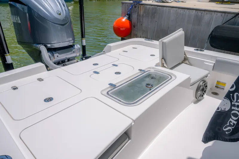 Slide: The Image of 2024 Contender 26 Bay boat deck with Yamaha engine and seating. - 25