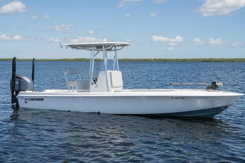 Slide: The Image of 2024 Contender 26 Bay boat on calm water under blue sky. - 3
